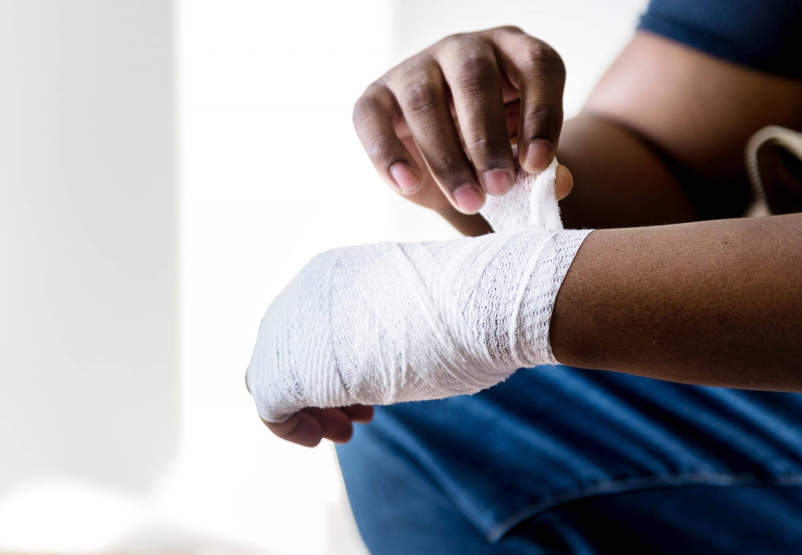 Image showing a man bandaging his hand after an on the job injury