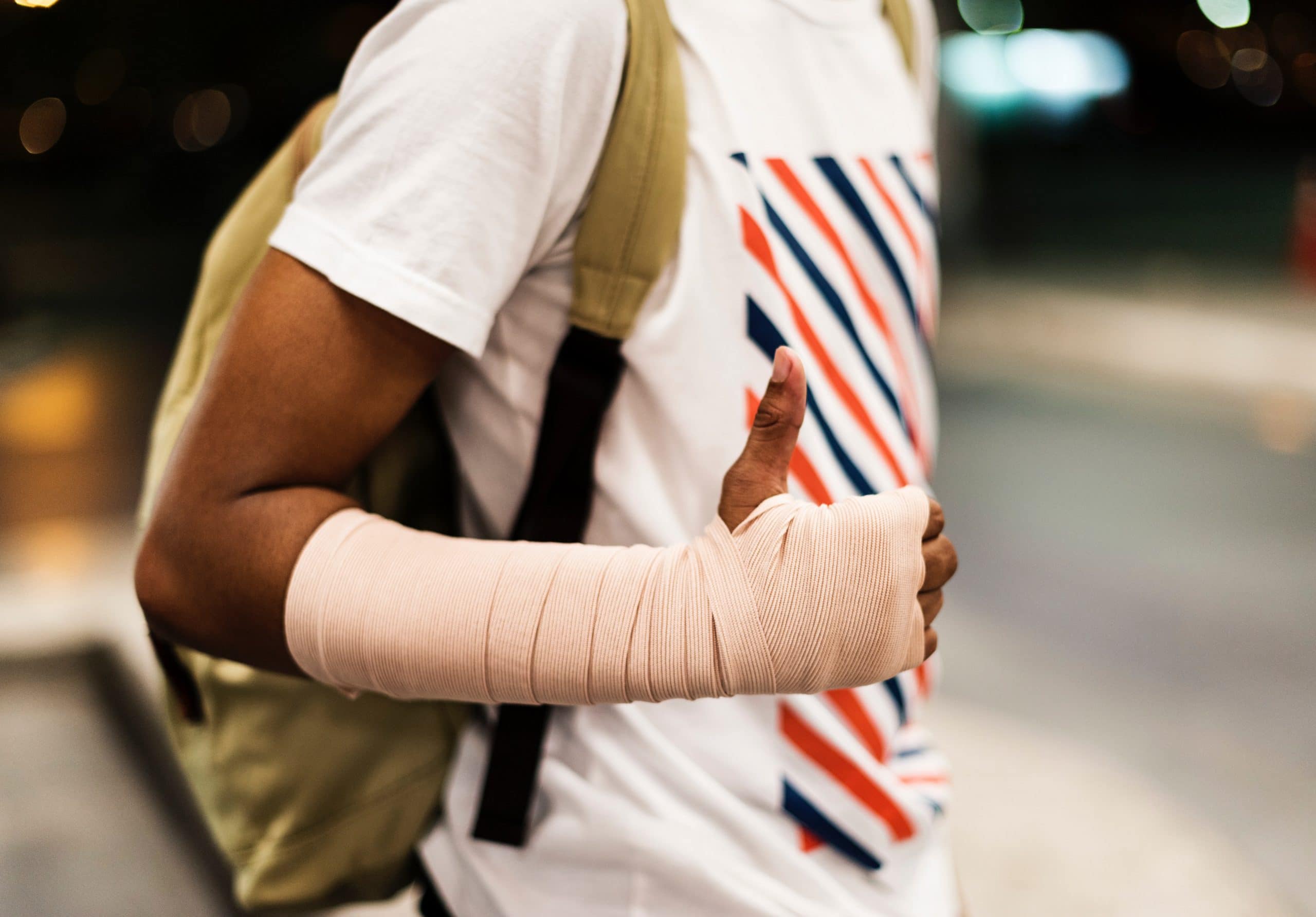 A man with his arm wrapped following a workplace injury