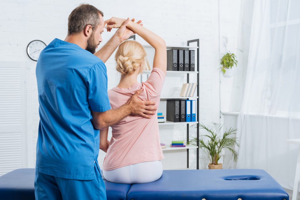 Doctor examining a patient’s shoulder in a clinical setting