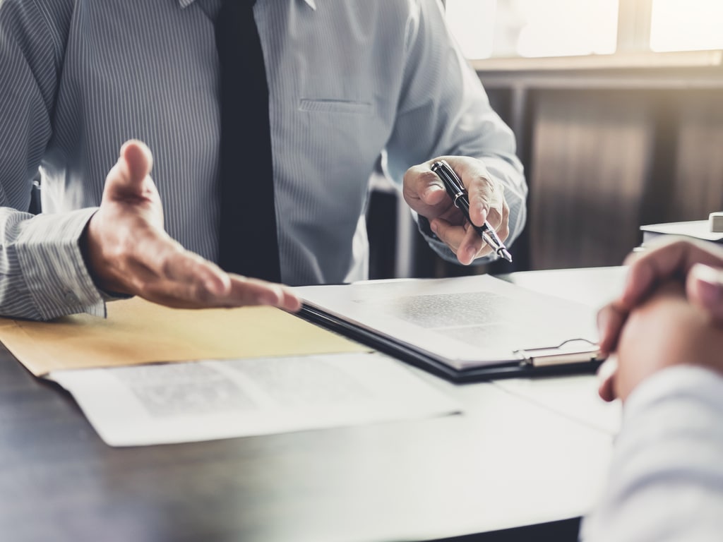 Lawyer discussing documents with a client