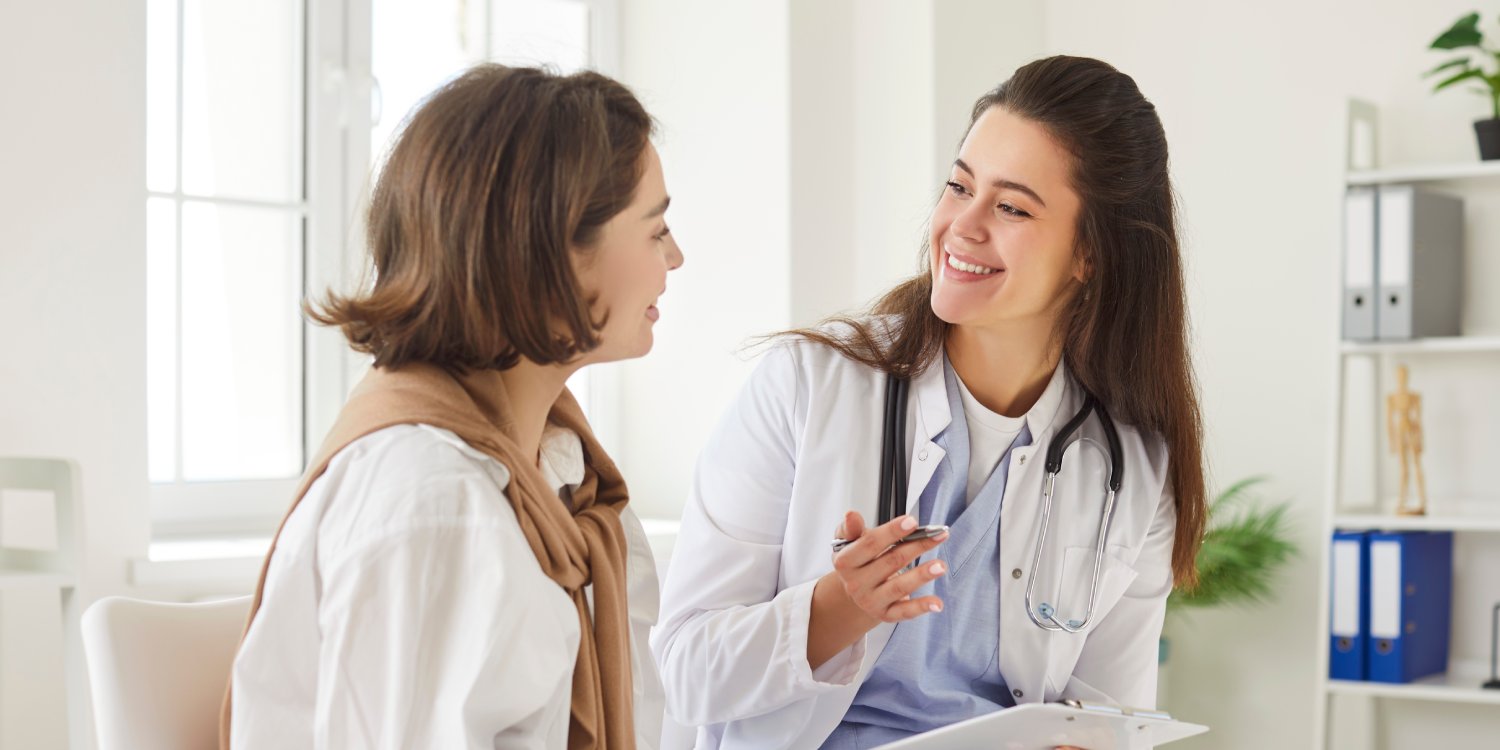Female New York accident doctor consulting with a patient during an injury evaluation in a medical office
